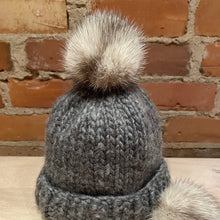 Load image into Gallery viewer, Small Mink Pom Pom on a Baby&#39;s Knit Hat
